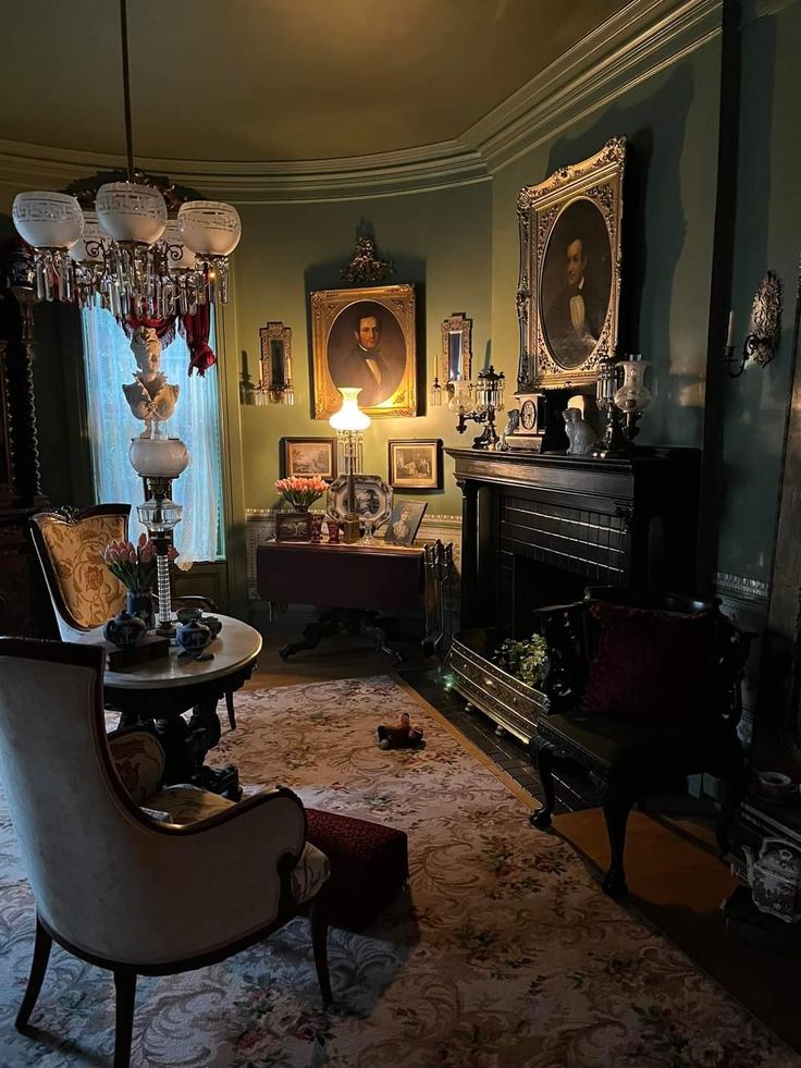 a living room filled with furniture next to a fire place and a painting on the wall