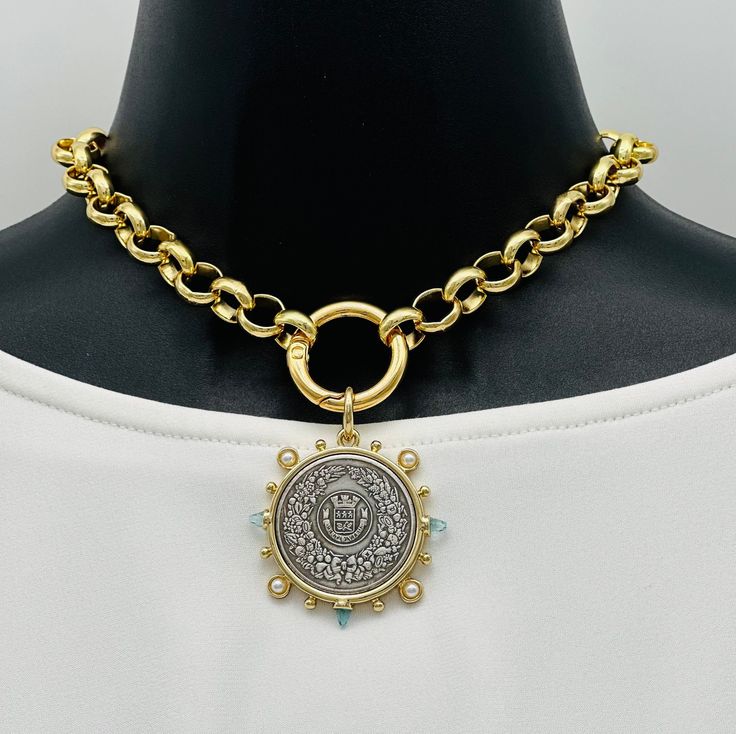 French Coin Rolo Chain Necklace: I love putting mixed metals together on a necklace, I think it's very unique and sophisticated. The French Horticole De Dison coin has a beautiful eye catching design, accented with small clear aqua CZ spikes and small pearls. The bezel is Cast Zinc Alloy and the coin is made of antiqued silver brass for an old world look. Coin can be taken off if you just want to wear the beautiful rolo chain or attach your personal charms. Both lead and nickel safe.  Large 11mm solid brass rolo chain has a glossy electro-plated finish. The chain is sprayed with an acrylic coating that helps prevent wear and tarnish. It is lead, nickel and cadmium free. Attached to an 18k gold filled EP (electroplated) over copper base. It's skin friendly and long lasting.  💎 Coin is 28mm Heirloom Brass Jewelry With Coin Pendant, Round Brass Coin Necklace, Tarnish Resistant, Brass Coin Charm Necklace Tarnish Resistant, Round Brass Coin Necklace Tarnish Resistant, Antique Gold Round Jewelry With Coin Pendant, Brass Medallion Necklace With Chain As Gift, Brass Medallion Necklace As Gift, Tarnish Resistant Round Brass Coin Necklace, Vintage Brass Chain Necklace Tarnish Resistant