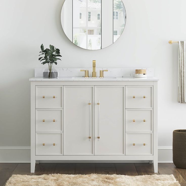 a white bathroom vanity with a round mirror above it and a rug on the floor