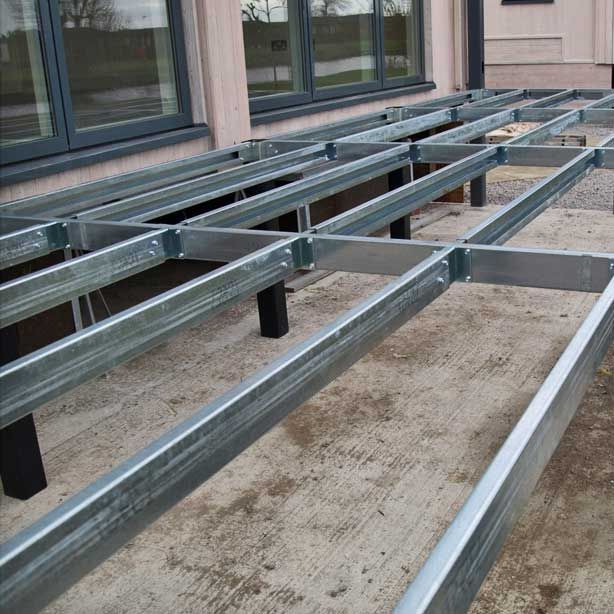 an empty bleachers in front of a building with no people or vehicles on it