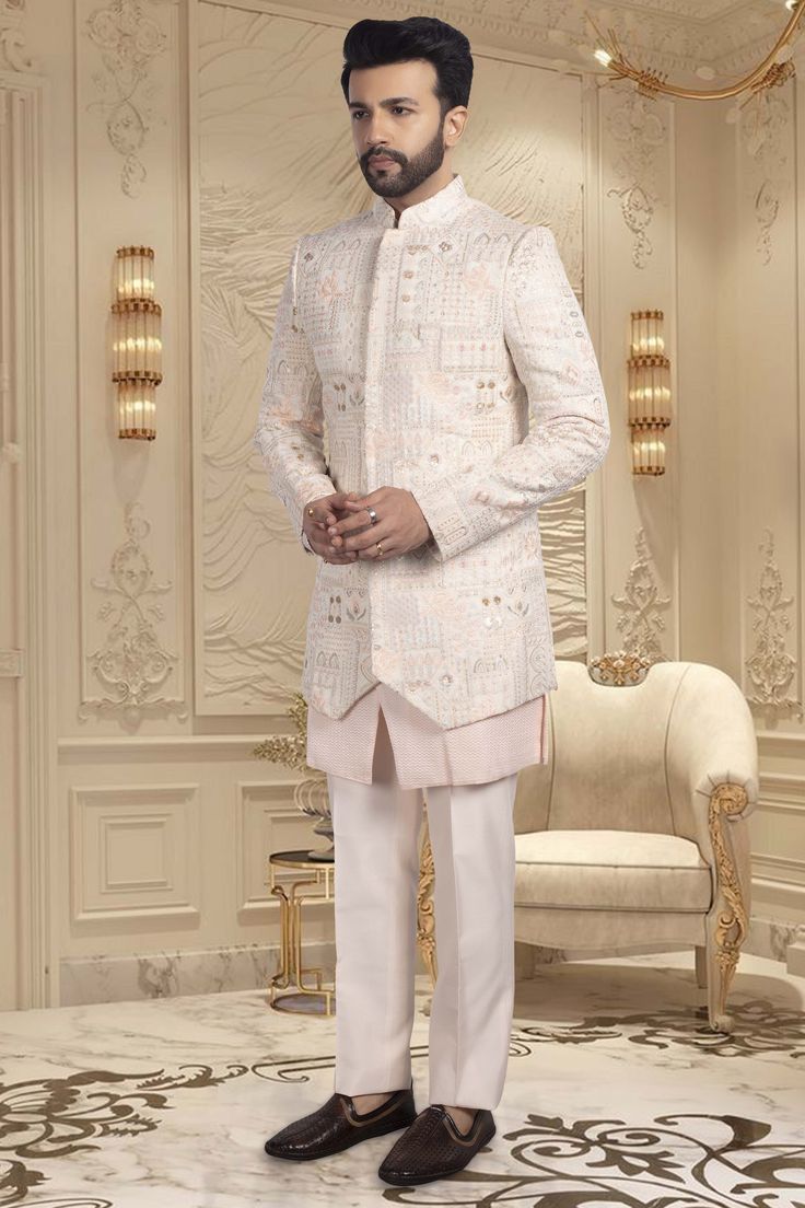 Introducing our R14-S61 Sherwani, the pinnacle of elegance and luxury. Handcrafted with seamless buttons, intricate thread work and shimmering sequins, this garment exudes sophistication and exclusivity. Step into a world of art and fashion with this premium sherwani. Elegant Nehru Jacket With Mirror Work For Festive Occasions, Elegant Wedding Kurta With Sequins, Elegant Embellished Sherwani For Eid, Elegant Sequined Traditional Wear For Weddings, Elegant Sequined Wedding Kurta, Elegant Festive Bandhgala With Mirror Work, Elegant Sequined Traditional Wedding Wear, Bollywood Style Fitted Suits With Resham Embroidery, Elegant Bandhgala With Resham Embroidery For Festive Occasions