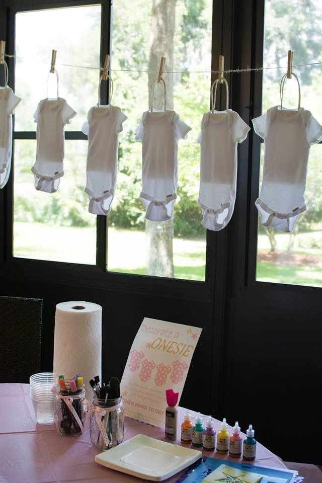 a table with some baby ones hanging from it's clothesline and other items