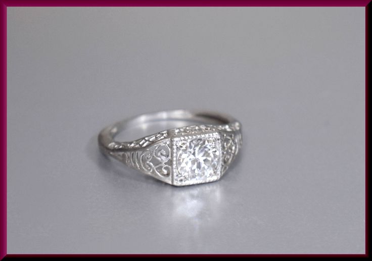 Set in platinum and dating from the art deco period of the 1920's, this luxurious engagement ring holds a center old European cut diamond that weighs approx. .75 ct and is J color and SI1 in clarity. Intricate filigree flows liberally throughout the entire mounting for an enchanting indulgence. ER 631M SIX MONTH LAY-AWAY AVAILABLE - PLEASE CONTACT ME TO SET UP A PLAN Timeless Formal Ring With Intricate Design, Silver Platinum Diamond Ring For Marriage, Platinum Diamond Ring For Marriage In Silver, Platinum Diamond Ring For Marriage, Luxury Platinum Filigree Ring With Intricate Design, Vintage Filigree Ring With Single Cut Diamonds As Gift, Elegant Filigree Solitaire Ring For Formal Occasions, Timeless Diamond Ring With Intricate Design As Gift, Timeless Platinum Ring For Marriage