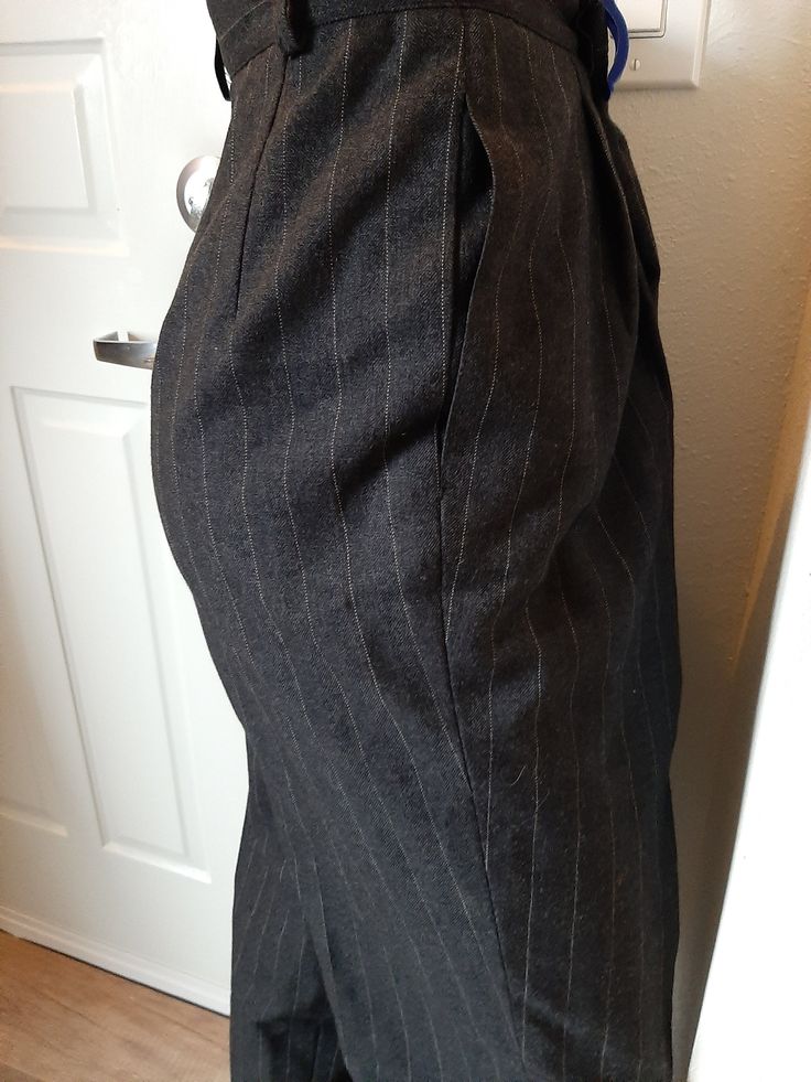 "Vintage Womens Wool High Waist Pleated Lined Pants Size 10 T/Curvey Excellent Vintage Condition. No Rips, Tears Or Stains. Shows Very Little Wear Made By Harve Benard by Benard Holtsman, Marked Size 10 Tall Dark Gray And White Pin Stripe Wool Fabric Dark Gray Satin Lining Fabric Possibly Nylon 6\" Gray Nylon Zipper 1.75\" Waistband And 5 Belt Loops, 2 Gray Buttons 2 Pleats On Each Side Front Hidden Side Pockets 4 Darts In Back Tapered Legs Roomy Through The Hips And Thighs Waist 29\" Hips 46\" Tailored Knee-length Formal Bottoms, Fitted Knee-length Pants For Fall, Formal Knee-length Bottoms For Fall, Tailored Classic Knee-length Bottoms, Elegant Fitted Knee-length Pants, Classic Knee-length Bottoms With Belt Loops, Fitted Knee-length Pants For Work, Classic Bottoms With Welt Pockets, Knee-length, Vintage Knee-length Formal Bottoms