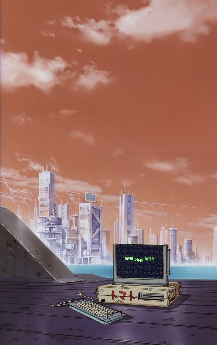 an old computer sitting on top of a wooden table in front of a cityscape