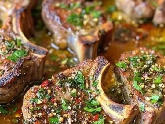 steaks with herbs and seasoning in a pan