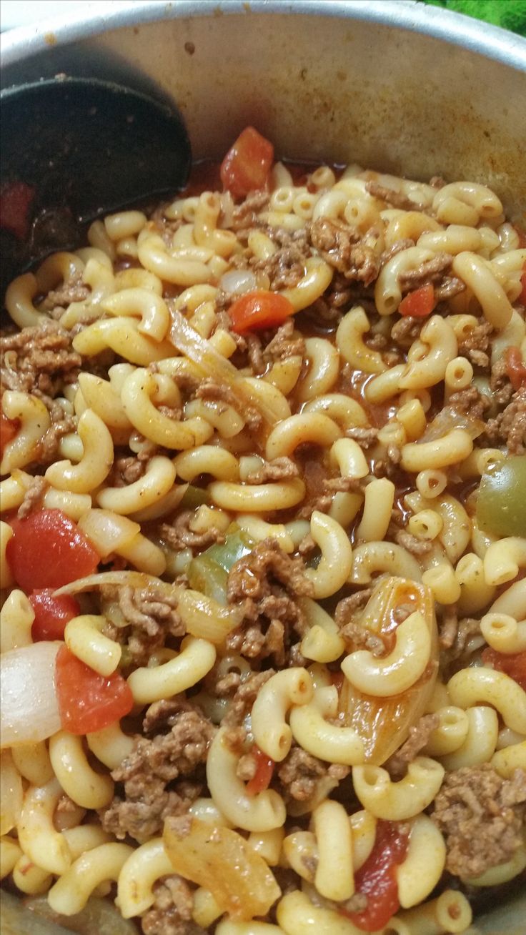 a skillet filled with pasta and meat