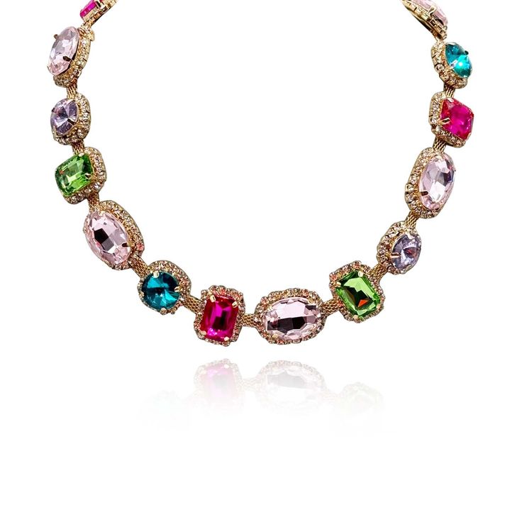 Introducing our stunning Multi-Color Stone Necklace, a versatile and vibrant accessory that effortlessly transitions from casual daywear to elegant evening attire. This necklace features a dazzling array of stones including Light Rose, Light Amethyst, Fuchsia, and various other colors, surrounded by delicate pave settings, all set on a soft gold chain for comfort and ease of wear. The combination of vibrant colors adds a playful and eye-catching dimension to any outfit, making it the perfect accessory to brighten up your wardrobe. Whether you're pairing it with a casual ensemble for a day out or dressing it up for a dinner date, this necklace is sure to make a statement and showcase your unique sense of style. Avoid contact with water and cosmetics, such as creams or perfumes. Clean with a Elegant Multicolor Necklace With Gemstone Accents, Elegant Multicolor Stone Necklaces, Elegant Multicolor Jeweled Necklaces, Multicolor Necklaces With Gemstone Accents For Formal Occasions, Party Crystal Necklaces With Gemstone Accents, Glamorous Multicolor Jeweled Jewelry, Multicolor Crystal Jewelry With Stones, Multicolor Crystal Necklaces With Stones, Multicolor Jeweled Necklace For Party