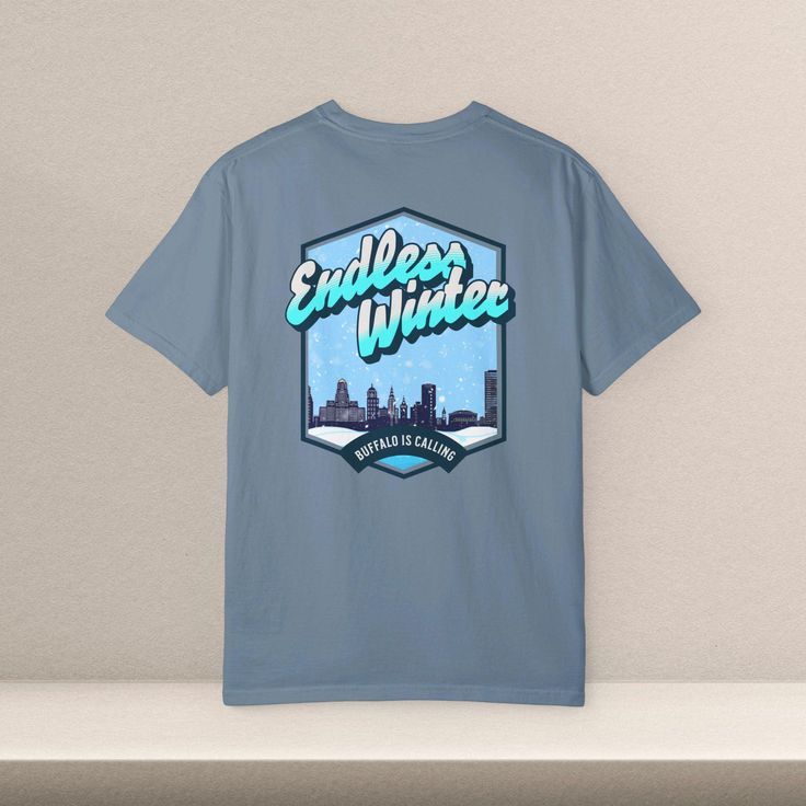 Introducing our exclusive Buffalo Snow Celebration Shirt, a proud addition to the City Collection by Icarus Tees Co! Embrace the spirit of the Queen City's legendary snowy weather with this unique and stylish tee. 🌨️ **Winter Wonderland Chic Crafted with love for Buffalo's snow enthusiasts, this shirt is more than just a garment; it's a celebration of the snowy charm that defines our beloved city. The design perfectly captures the essence of Buffalo's winter wonderland, making it a must-have for locals and visitors alike. 🏙️ **City Collection Elegance Part of our specially curated City Collection, this shirt seamlessly blends comfort with urban style. The high-quality fabric ensures a cozy fit, while the design proudly showcases Buffalo's resilience in the face of winter's chill. It's no Blue Crew Neck T-shirt, Urban Winter Tops With Logo Print, Winter Relaxed Fit T-shirt With Logo Print, Urban Graphic Print Tops For Winter, Urban Short Sleeve Tops For Winter, Winter Logo Print Crew Neck T-shirt, Winter Crew Neck T-shirt With Logo Print, Urban Winter T-shirt With Screen Print, Winter Streetwear Logo Print T-shirt