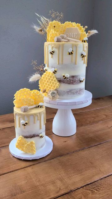 three tiered cake decorated with bees and flowers