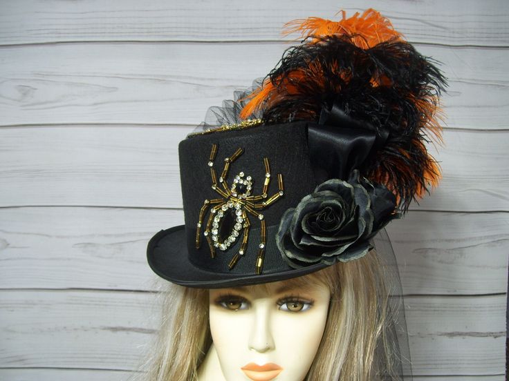 Ladies Black top hat with two large beaded and rhinestone spiders with black roses, black and orange ostrich feathers and a black bustle and train on the back. This is a black hard felt costume grade top hat. PLEASE MEASURE YOUR HEAD! This hat is 22.5" for the inside circumference. I will include a peel and stick hat sizer if you need it smaller, but I cannot make it larger. Please keep this in mind when deciding. Check out my other items in my shop. Thank you for stopping by. All sales are final! Please keep that in mind when purchasing. Check out my other hats and fascinators.  https://www.etsy.com/shop/MsPurdy I ship many times a week. This hat will ship priority mail within the U.S. with tracking number. Black Top Hat For Halloween, Black Themed Top Hat For Halloween, Black Halloween Themed Top Hat, Adjustable Black Top Hat For Halloween, Witchy Black Top Hat For Halloween, Themed Black Top Hat For Halloween, Black Whimsical Costume Accessories For Party, Whimsical Black Costume Accessories For Party, Whimsical Black Mini Hats For Halloween