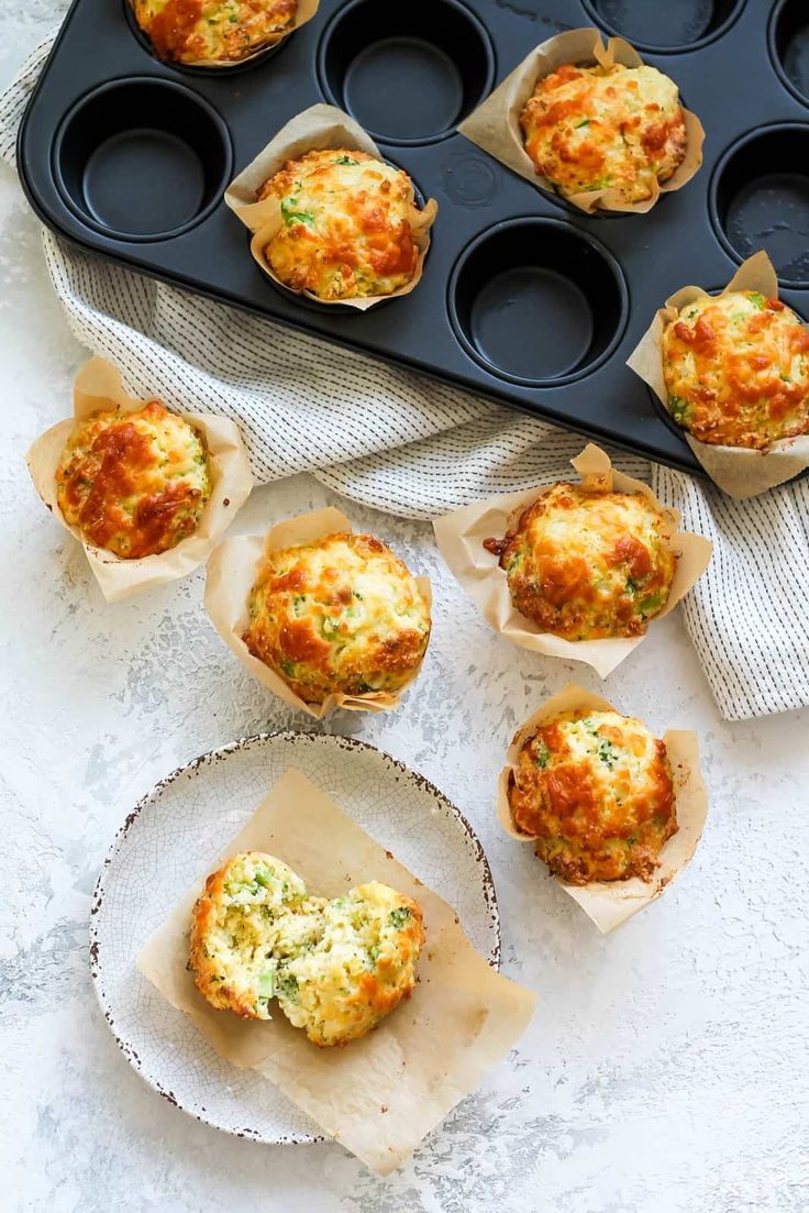 some muffins are sitting on a plate next to the muffin tins