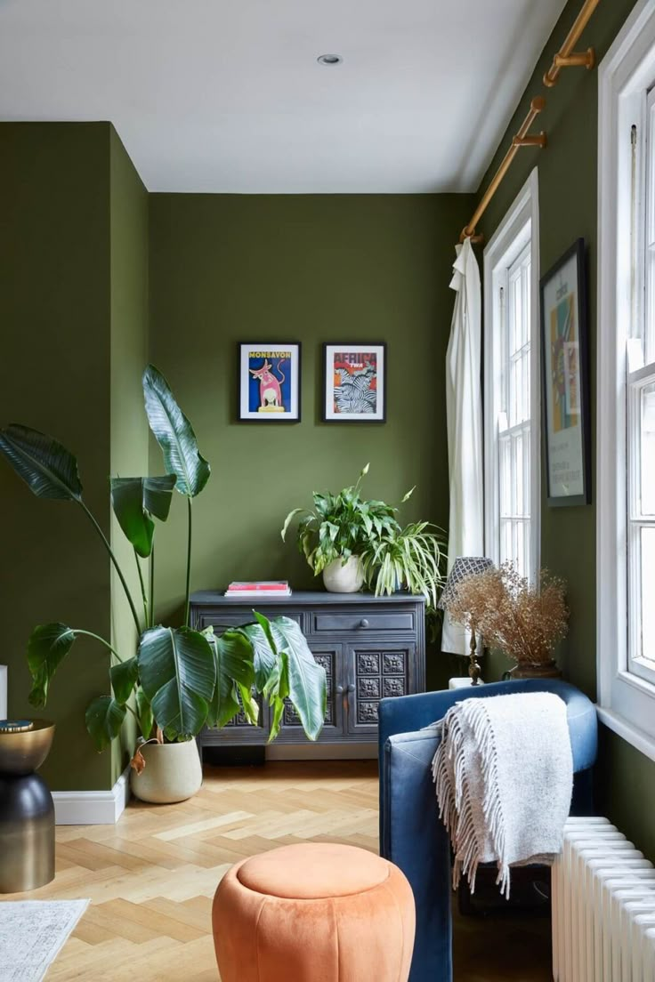 a living room filled with furniture and plants