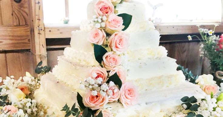 a wedding cake with pink and white flowers on it