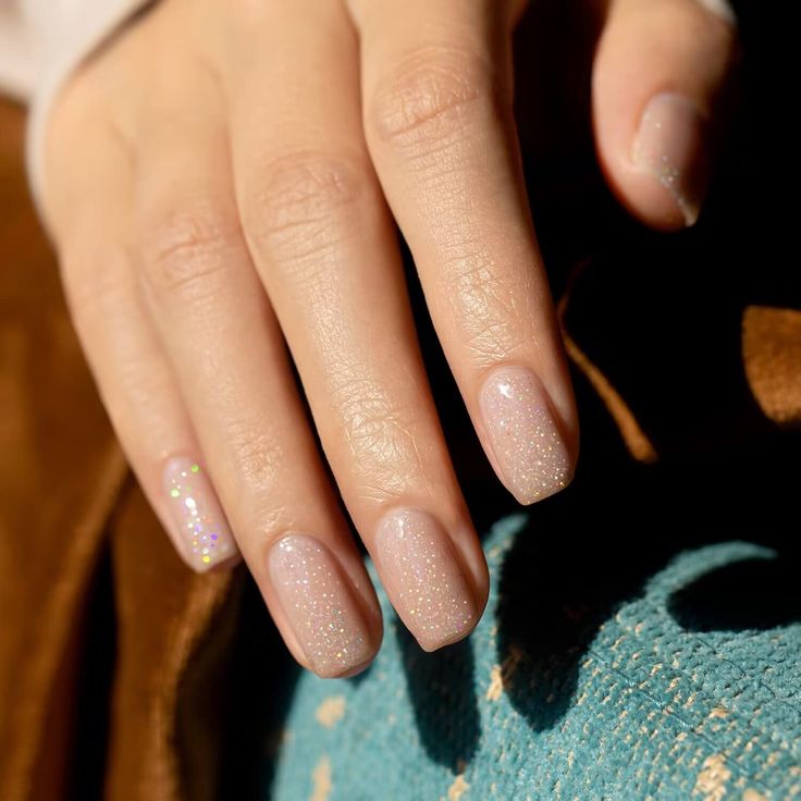 Not Just Nude Colors-The nude-toned color is littered with rainbow glitter that reflect and twinkle no matter where the light catches the nail. Nude nails always bring natural and pure beauty to all of ages and glitter gel nail polish is one of the most stylish ways to wear this trend. Soft sheer pink nude series colors. Use this shade of cream on its own or as an accent for your nail art. The nude-toned color is littered with rainbow glitter that reflect and twinkle no matter where the light ca Nude Shimmer Nails, Nude Glitter Nails, Nails Shimmer, Nail Nude, Nude Nails With Glitter, Glitter Gel Nail Polish, Short Almond Nails, Uv Nail Lamp, Glitter Gel Polish