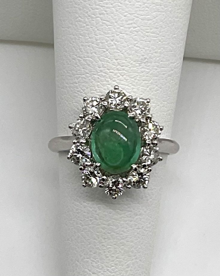 Beautiful estate genuine oval cabochon cut emerald and natural diamonds in solid 18k white gold. Emerald is prong set in the center of the ring is an A quality 8.5x6.5 mm. and 1CTW.  Has a few natural features like veins, a cloud and some dark inclusions.  Diamonds all prong set, there are 10 round cut stones 1.2 TCW F-G color, VS2-SI1 clarity. Will fit 5.75 US finger size. Truly beautiful ring. Was appraised by 3rd party independent GIA graduate jeweler.  Please ask any questions you might have. Thank you. Exquisite Oval Emerald Ring In Platinum, Oval Emerald Ring In White Gold With Diamond, Oval Emerald Ring With Halo Setting In Platinum, Elegant Oval Platinum Emerald Ring With Halo Setting, Oval Platinum Emerald Ring With Halo Setting, Hallmarked Oval Emerald Ring In Platinum, Oval Hallmarked Emerald Ring In Platinum, Oval Brilliant Cut Emerald Gemstones, Oval Emerald Ring With Prong Setting In Platinum