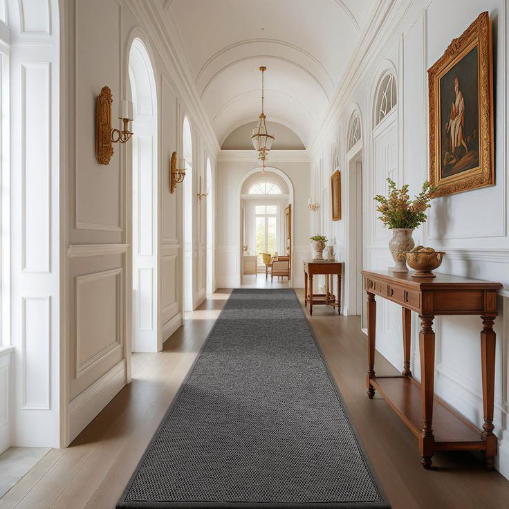 the hallway is clean and ready for guests to use it as an entrance way in this house