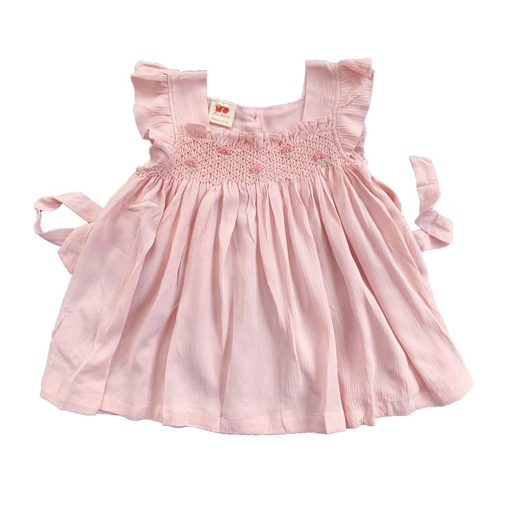 This lovely short-sleeved dress is made from 100% cotton gauze fabric, which is lightweight, airy, slightly crinkled and great for a casual look. It has very special color: light pink sand color, with intricate smocked and embroidered as usual. Comfortable, perfect for everyday wear and outgoing activities. * 100% Cotton * 100% Handmade * Tie at the back * Lightweight, soft cotton, comfortable, and ready to play * Hand wash or machine wash on a delicate setting We are based in Sydney, New South Summer Cotton Smocked Dress With Flutter Sleeves, Cute Pink Smocked Dress With Smocked Back, Summer Smocked Flutter Sleeve Dress For Daywear, Summer Flutter Sleeve Smocked Dress For Daywear, Summer Smocked Dress With Flutter Sleeves For Daywear, Pink Short Sleeve Dress With Smocked Back, Feminine Smock Dress With Short Sleeves, Cotton Smocked Short Sleeve Dress For Daywear, Pink Bohemian Smocked Dress For The Beach