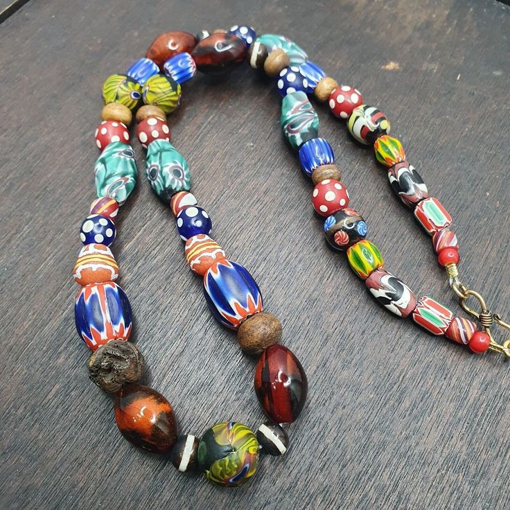 Transport yourself to the vibrant streets of Venice with this stunning vintage necklace. The multicolor millefiori Style glass beads are Inspired of the famous Murano glasswork, giving this piece an artistic and unique charm. The necklace is beaded in a 24-inch length that is perfect for adding a pop of color to any outfit. This necklace is a one-of-a-kind piece that stands out in any jewelry collection. Its vintage charm and artful design make it a must-have for any fashion enthusiast. The necklace is in excellent condition, ready to be worn and enjoyed for years to come. Elegant Multicolor Wooden Beads Necklaces, Vintage Glass Beaded Necklaces With Oval Beads, Vintage Glass Necklaces With Oval Beads, Vintage Glass Necklace With Oval Beads, Single Strand Glass Spiritual Necklace, Single Strand Spiritual Glass Necklace, Spiritual Single Strand Glass Necklace, Vintage Glass Beaded Necklaces With Colorful Beads, Artisan Beaded Necklaces With Large Glass Beads