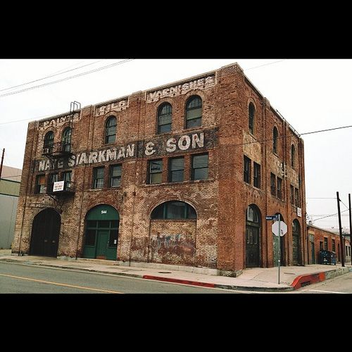 an old brick building sitting on the corner of a street