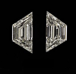 pair of diamond earrings on black background with clippings to the left and right side