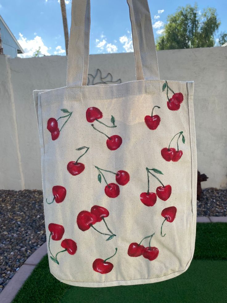 Hand painted Cherry print tote bag! Valentines Tote Bag Painting, Easy Canvas Bag Painting, Trendy Cheap Bags With Strawberry Print, Totes Bag Design Ideas, Artistic Tote Bags For Spring, Artistic Spring Tote Bag, Casual Hand Painted Bags For Everyday, Painted Beach Bag, Red Hand Painted Bags