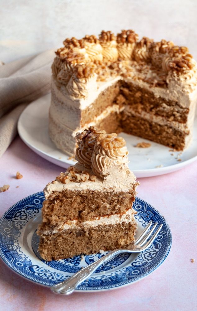 a piece of cake on a blue and white plate with a fork next to it