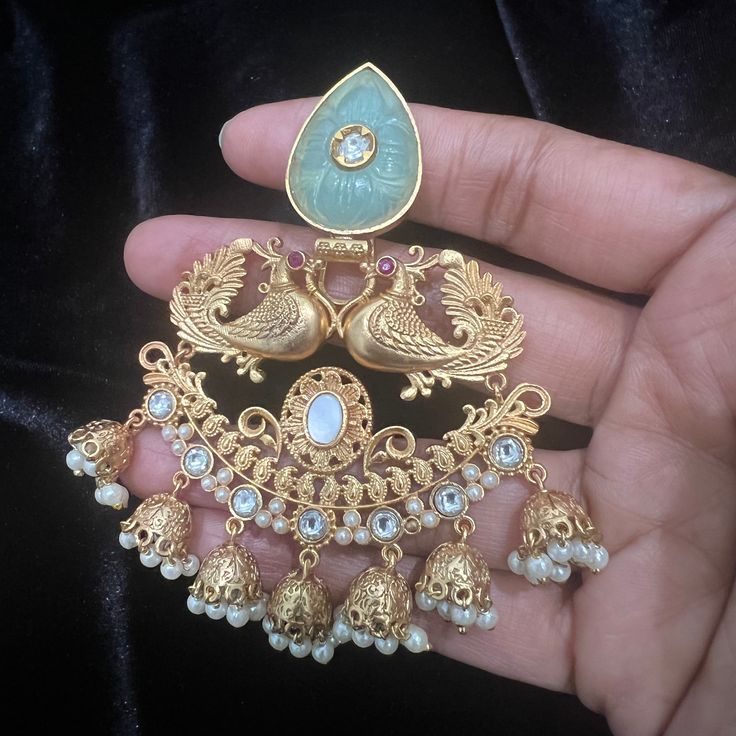 "These Jhumka Earrings set have an excellent finish and gives out an exquisite sense of style. If you are looking for an amazing Fashion Jewelry set for special occasions such as Anniversary, Engagement, Party, Wedding or for gifting , then your search ends here. Handmade Indian Temple Jewelry, best to wear it for traditional ceremonies or Indian wedding. This bridal jewelry has ethnic finish. It has Cubic Zircon stones with ruby and emeralds. It is a Bollywood style one gram jewelry. There are Temple Jewelry Style Bridal Earrings, White Wedding Jewelry With Peacock Design, Temple Jewelry Jhumkas As A Gift, Gift Temple Jewelry Jhumkas, Temple Jewelry Bridal Earrings For Celebration, Fusion Chandbali Earrings With Intricate Design, Peacock Design Pendant Jewelry For Wedding, Fusion Style Peacock Design Earrings For Wedding, Hand Set Pendant Earrings For Festivals