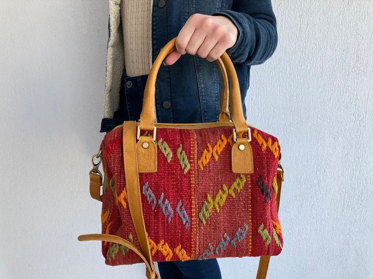 Bohemian Leather Tote Duffle Bag, Traditional Travel Satchel With Leather Handles, Bohemian Brown Leather Duffle Bag, Brown Bohemian Duffle Bag With Leather Handles, Bohemian Brown Duffle Bag With Leather Handles, Bohemian Leather Tote Travel Bag, Bohemian Leather Duffle Bag For Everyday Use, Traditional Satchel For Travel, Vintage Weekender Bag With Leather Trim For Daily Use