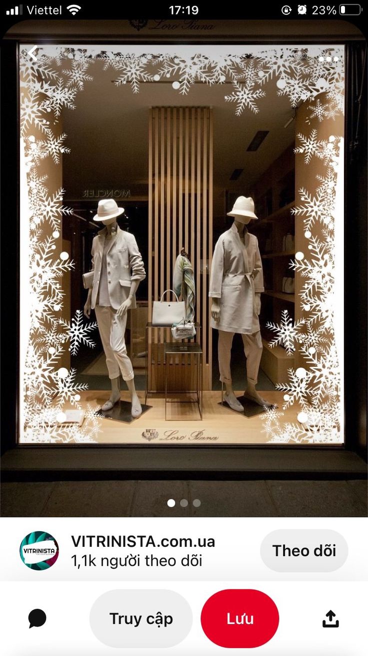 two mannequins dressed in suits and hats are seen through a window display