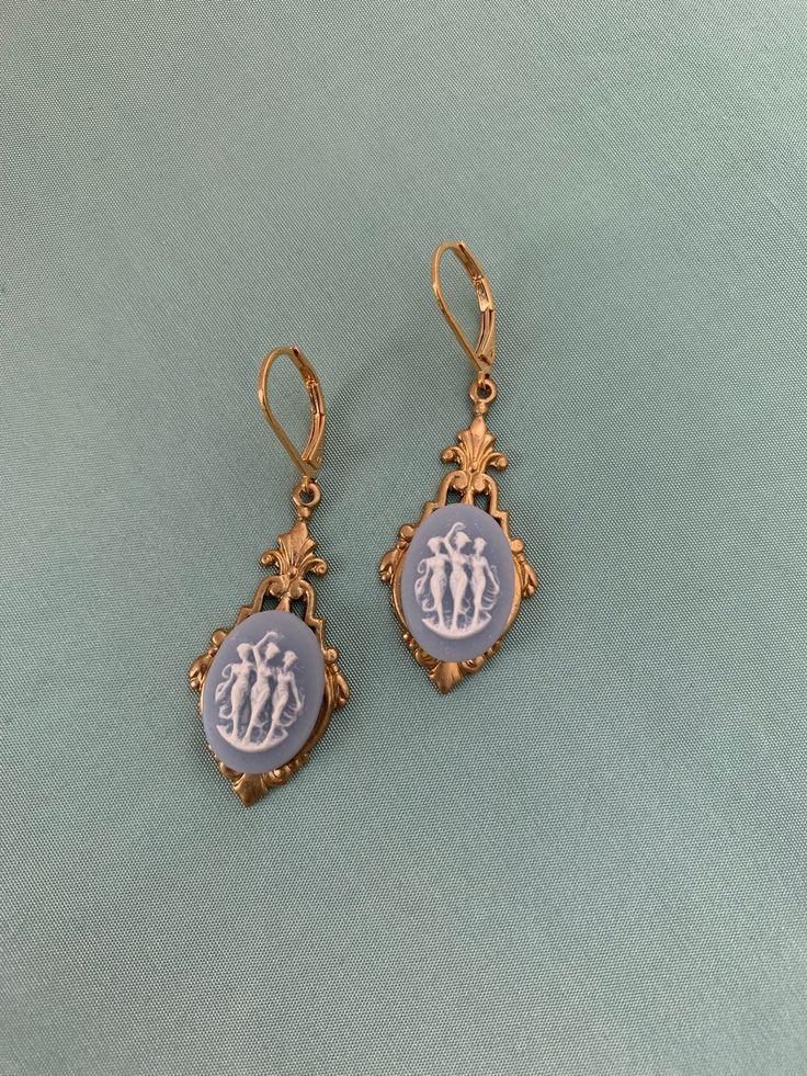 "Victorian THREE GRACES Earrings, 16k gold plated brass lever backs, late 19th reproduction Victorian Cameo earrings This listing is for a pair of reproduction late 19th century VICTORIAN design earrings, created with a gorgeous Blue and White THREE GRACES Cameo in a historic and classical design, finished with 16k gold plated brass Lever backs. I simply adore this classic Victorian design: perfect for your late 19th century re-enactments: versatile and lovely design and dangle! These are LIGHTW Gold Cameo Drop Earrings, Antique Brass Jewelry With Lever Back Ear Wires, Gold Cameo Earrings For Collectors, Vintage Yellow Gold Earrings With Lever Back, Gold Cameo Vintage Earrings, Vintage Gold Cameo Earrings, Vintage Brass Medallion Earrings, Vintage Cameo Drop Earrings, Vintage Drop Earrings With Lever Back