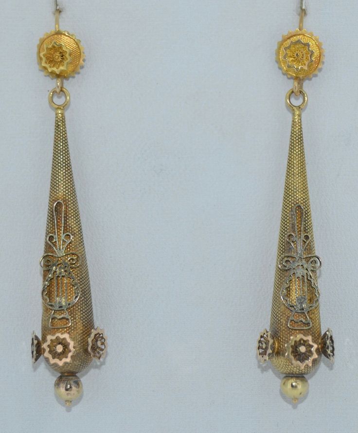 A lovely lengthy pair of Georgian era earrings. These earring are crafted from 14K Yellow gold. The tops appear to have been conversion to hooks, most likely they were day and night earrings. The decoration at the front is original the hooks appear to have been replaced. The tops feature a flower with a textured background. They suspend the long drop The drops are decorated with lovely appliqués in 14K yellow gold with a textured background. They match the tops. These earrings are in good condit Antique Yellow Gold Ceremonial Earrings, Antique Yellow Gold Drop Earrings, Victorian Yellow Gold Drop Earrings, Victorian Style Ceremonial Earrings For Pierced Ears, Victorian Style Ceremonial Dangle Earrings, Antique Yellow Gold Earrings For Formal Events, Antique Yellow Gold Earrings For Formal Occasions, Antique 14k Gold Hallmarked Earrings, Antique Ceremonial Dangle Earrings