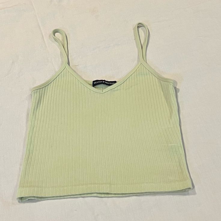 Brandy Melville Lime Green Ribbed Tank Top Light Green Cotton Spaghetti Strap Os -Limited Edition No Longer Sold -Super Cute & Unique Color -100% Cotton -Brand New Condition It’s Hardly Been Worn And It’s Super Soft Love Brandy Melville? Check Out My Closet For Lots More Beautiful, Popular Items! Bundle To Save 10% Off 3 Or More Items! Orders Ship Within 1-2 Business Days. Feel Free To Send Offers And Ask Questions! All Offers Are Considered! Thanks For Checking Out My Closet & Happy Shopping! N Ribbed Camisole Tops For Spring, Spring Ribbed Camisole Top, Trendy Ribbed Camisole For Spring, Ribbed Summer Camisole, Summer Ribbed Tank Top With Spaghetti Straps, Summer Ribbed Spaghetti Straps Tank Top, Basic Ribbed Camisole For Summer, Green Seamless Spaghetti Strap Top, Summer Ribbed Camisole Top