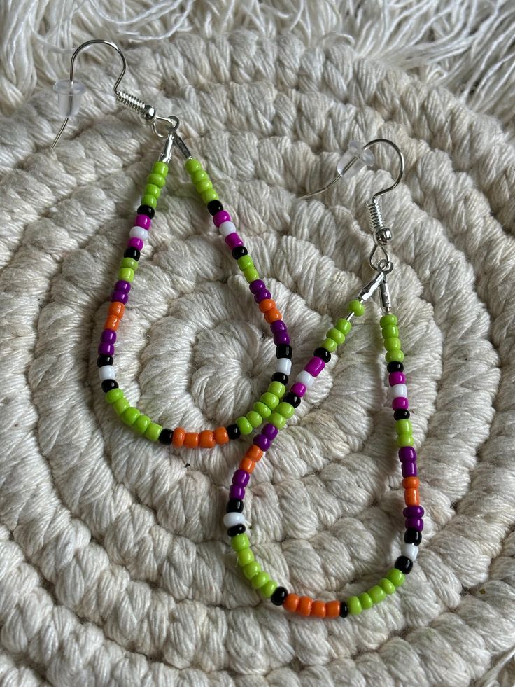 Lime green colored teardrop loop dangle earrings. Made with multicolored glass seed beads attached to a hypoallergenic earring ring fixing. Green Teardrop Earrings For Jewelry Making, Green Hoop Earrings With Dangling Beads For Gift, Dangle Teardrop Earrings With Tiny Beads As Gift, Bohemian Green Teardrop Earrings With Ear Wire, Gift Teardrop Dangle Earrings With Tiny Beads, Green Beaded Dangle Teardrop Earrings, Green Beaded Dangle Hoop Earrings, Trendy Green Dangle Hoop Earrings, Green Bohemian Teardrop Drop Earrings