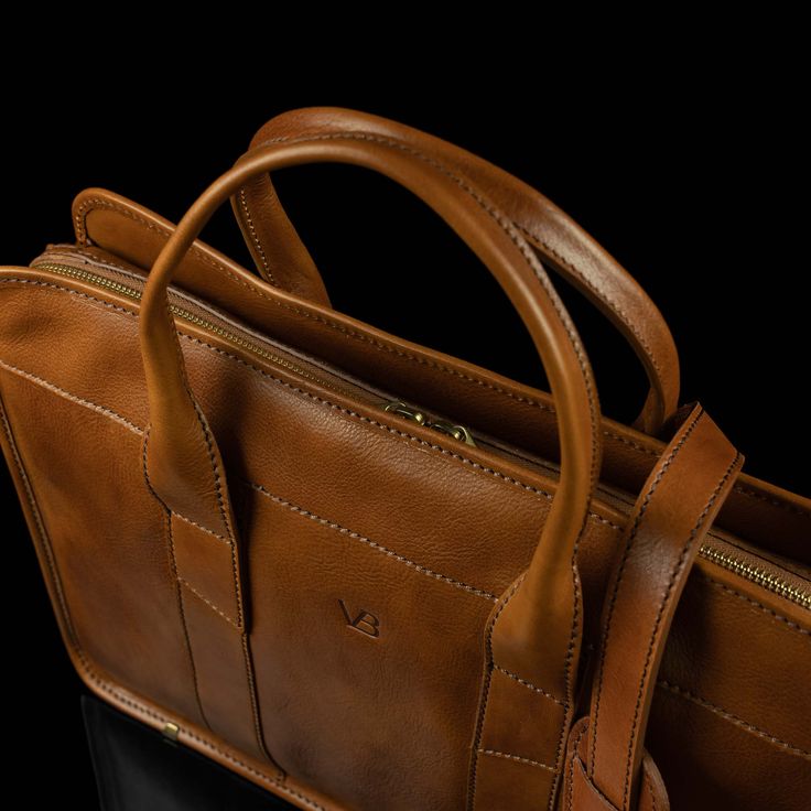 With everyday practicality in mind, the Exquisite slim leather laptop briefcase promises to accompany a modern professional on a day-to-day basis. Keep your business essentials safe and yourself looking outstanding. Expertly handcrafted in Florence, Italy using premium full-grain vegetable-tanned cow leather, the Exquisite puts practical minimalism front and center. The bag is slim yet spacious—easily carry your laptop and other business essentials with you nicely organized. The design achieves Leather Laptop Bag For Men, Designer Laptop Bag, Work Essentials, Laptop Bag For Women, Business Essentials, Laptop Briefcase, Leather Laptop Bag, Work Style, Man Style