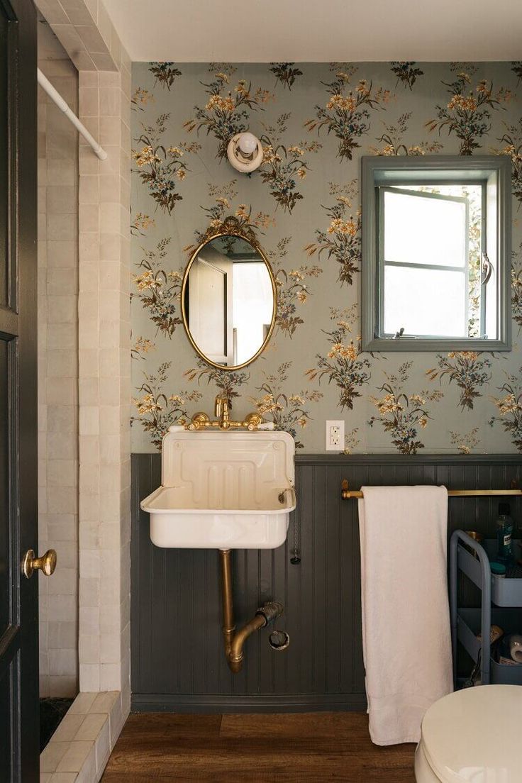 a bathroom with a sink, mirror and towel rack