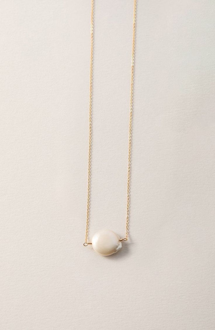 Give your look an ethereal finish with this simple freshwater pearl detailed necklace. 16" length 11-12mm pearl width 14K gold fill/freshwater pearl
 Made in the USA White Single Strand Pearl Necklace With 14k Gold Filled, White Single Strand Pearl Necklace In 14k Gold, White Pearl Necklace With 14k Gold-filled Pearl Pendant, Minimalist Single Strand Baroque Pearl Necklace, White 14k Gold-filled Pearl Pendant Necklace, Minimalist Pearl Pendant Necklace In 14k Gold, White Pearl Pendant Necklace In 14k Gold Filled, White Pearl Pendant Necklace In 14k Gold, Minimalist 14k Gold-filled Pearl Pendant Necklace