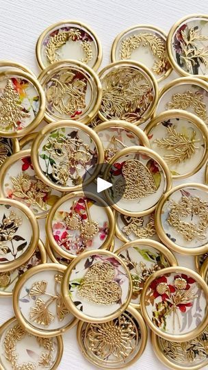 a pile of gold and white plates sitting on top of a table next to each other