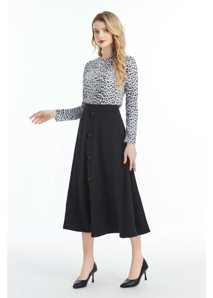 Our Black Midi Skirt with Front Button Detail is the perfect blend of sophistication and style. Crafted from high-quality denim fabric, this skirt is soft to the touch and comfortable to wear. It features a midi length, which falls below the knee, making it perfect for both casual and formal occasions. The skirt is designed with a button detail that runs down the front of the skirt, adding a touch of elegance and femininity to the overall design. The skirt also features a hidden back zipper clos Business Casual Midi Length Bottoms For Fall, Chic Fall Skirt With Button Closure, Workwear Bottoms With Button Closure And Midi Length, Fall Office Skirt With Button Closure, Casual Maxi Skirt With Button Closure For Work, Casual Workwear Maxi Skirt With Button Closure, Chic Fall Skirt With Button Zip Fly, Chic Skirt With Button Zip Fly For Fall, Casual Workwear Skirt With Button Closure