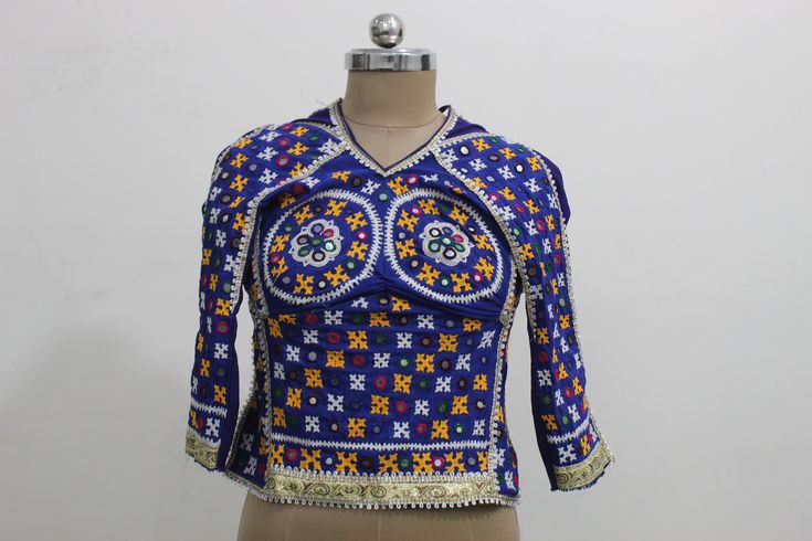 DESCRIPTION Authentic Vintage hand embroidered CHOLI BLOUSE from the the Nomadic tribal group of India called the Rabaris. ONE OF A KIND ! These Cholis are ornately hand embroidered by the banjara tribals and embellished with mirror insets. It has vibrant and colorful crewel chain stitch embroidery workdobe in tribal folk patterns from gujarat rajasthan and sindh. This gorgeous hand embroidered choli blouse top has an open back with two adjustable tie back strap closures at the neck and at the w Bollywood Festive Blouse For Rituals, Traditional Blouse For Navratri Rituals, Unstitched Choli Blouse For Festive Rituals, Traditional Festive Blouse For Rituals, Fitted Choli With Multicolor Embroidery And Motifs, Bohemian Fitted Lehenga With Multicolor Embroidery, Fitted Bohemian Lehenga With Multicolor Embroidery, Festive Blue Tops With Motifs, Bohemian Zari Work Tops For Diwali