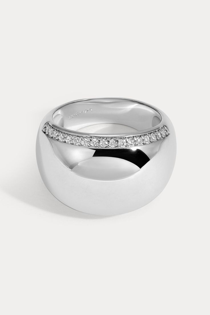 Bold and lightweight, this smooth domed design is embellished with pavé detailing along both edges of the ring. Available in 14kt gold plated brass or Rhodium plated brass Stones are White Cz, and measure 1.0mm each Dome width measures approx. 15mm Dome height measures approx. 4mm Runs true to size Product Care: METAL: Use a soft cloth to gently wipe clean, then remove any remaining impurities with mild diluted soap. Rinse with warm water and dry thoroughly before storing in the provided jewelry Lili Claspe Jewelry, Dome Ring, Domed Ring, Platinum Ring, Jewelry Cleaner, The Ring, 14kt Gold, Jewelry Pouch, Stone Rings