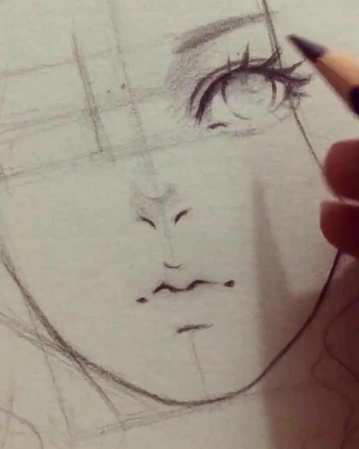 someone is drawing a woman's face with pencils