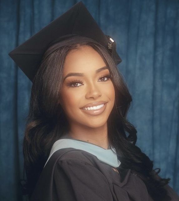 a woman wearing a graduation cap and gown