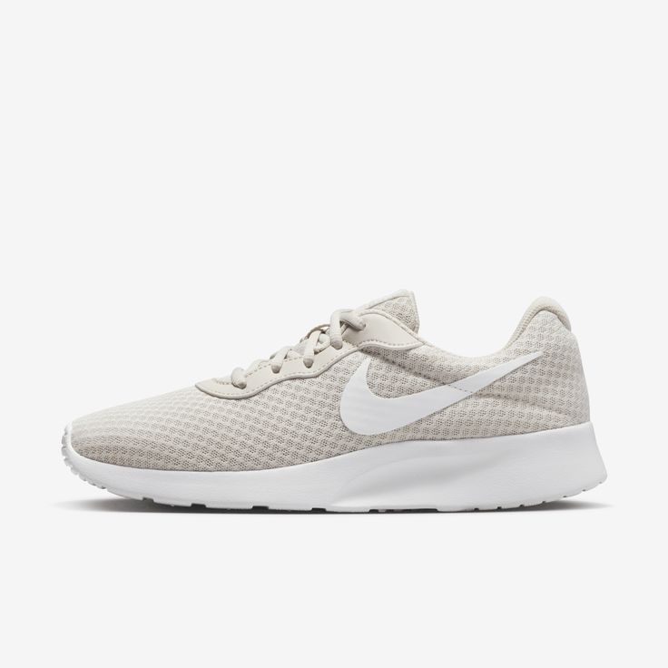 Forget the hype. The Nike Tanjun brings you simplicity at its best. Made with at least 20% recycled content and 100% recycled polyester laces, no detail is overlooked on this one. Lightweight. Airy. Comfortable. These are just words. This shoe is all you need. Casual Beige Running Shoes With Laces, Lightweight Casual Sneakers With Round Toe, Comfortable Nike Running Shoes With Synthetic Material, Comfortable Nike Synthetic Running Shoes, Casual Nike Breathable Running Shoes, Low-top Lightweight Sneakers For Sports, Lightweight Low-top Sports Sneakers, Lightweight Low-top Sneakers For Light Sports, Sporty Lightweight Synthetic Sneakers