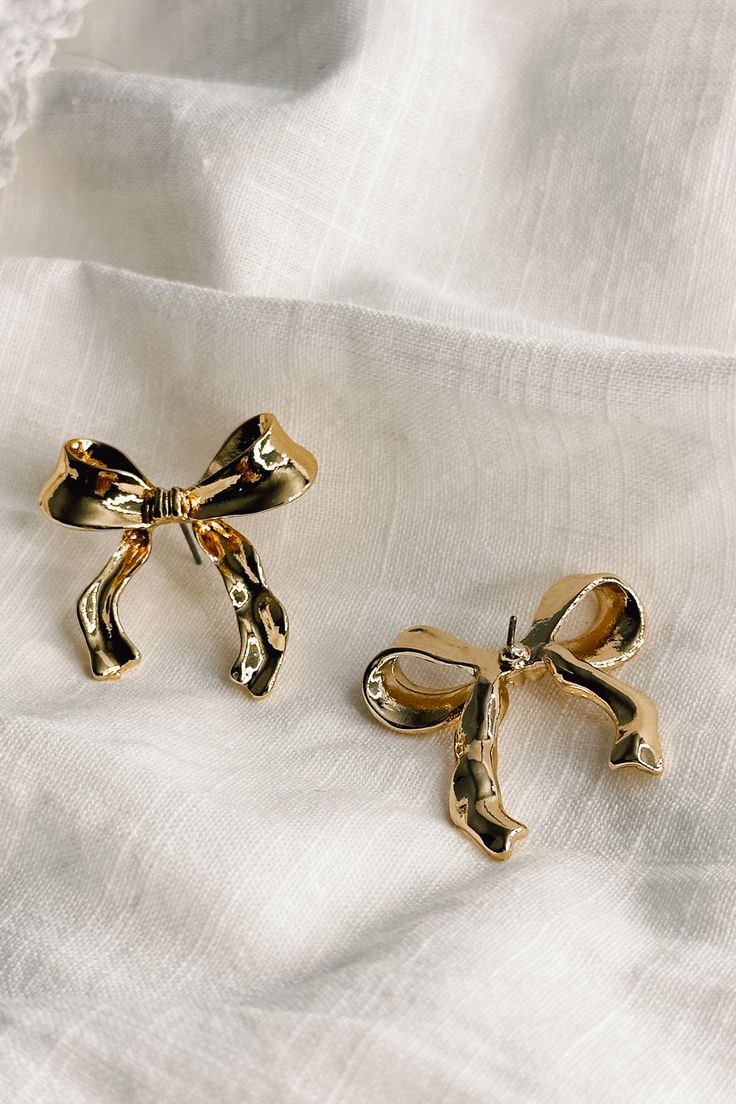 Flat lay view of the Lois Gold Bow Stud Earrings which features gold bow shaped earrings with stud back closures Bow Earrings Gold, Everyday Elegance, Bow Earrings, Understated Elegance, Dream Jewelry, Stud Earring, Earrings Gold, Dream Wardrobe, Unique Pieces