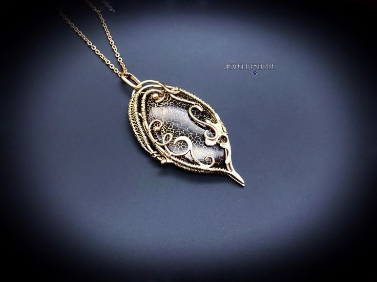 This Gothic gemstone pendant wrapped in brass wire with natural black gold Dragon Veins Agate.                                                                                                                                                                                                                                                                          It can be a unique decoration for a festive occasion or lovely gift. Jewelry by Jewelryshore -https://jewelryshore.etsy.com Unique Gold Wire Wrapped Necklaces, Gold Amulet Style Hand Wrapped Necklace, Unique Gold Hand Wrapped Necklace, Hand Wrapped Gold Jewelry Gift, Hand Wrapped Copper Gold Necklace, Hand Wrapped Gold Copper Necklace, Gold Unique Hand Wrapped Necklace, Bronze Hand Wrapped Pendant Jewelry, Hand Wrapped Bronze Pendant Jewelry