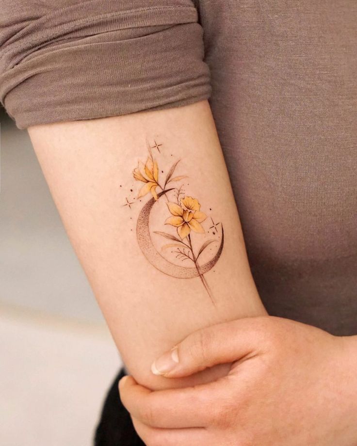 a woman with a flower tattoo on her arm