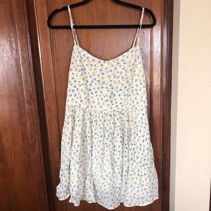 Creme And Ditsy Blue Floral Sundress From Urban Outfitters. Zip Back And Adjustable Straps. Crepe-Type Material (Slightly More Wrinkled Than Usual But Always Looks A Little Wrinkled). Spring Sundress With Ditsy Floral Print And Spaghetti Straps, White Mini Floral Dress With Ditsy Print, Ditsy Floral Print Sundress For Brunch, Casual Ditsy Floral Print Dress With Spaghetti Straps, White Floral Dress With Spaghetti Straps For Spring, White Ditsy Floral Print Dress For Spring, Summer Sundress With Ditsy Floral Print For Daywear, Ditsy Floral Print Sundress For Summer Daytime, White Ditsy Floral Print Sundress For Spring