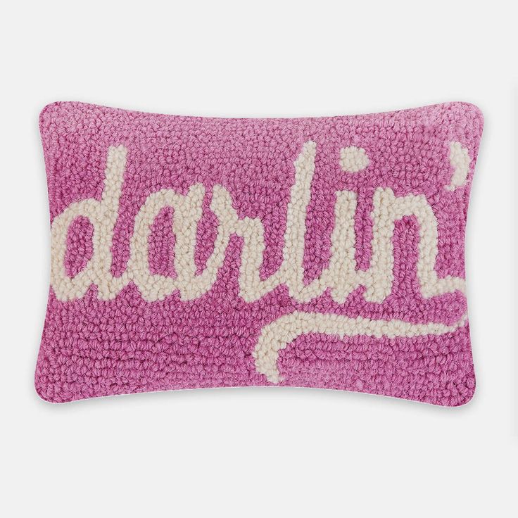 a pink and white pillow with the word darlin on it