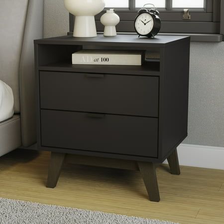 a night stand with two drawers and an alarm clock on the nightstand next to it